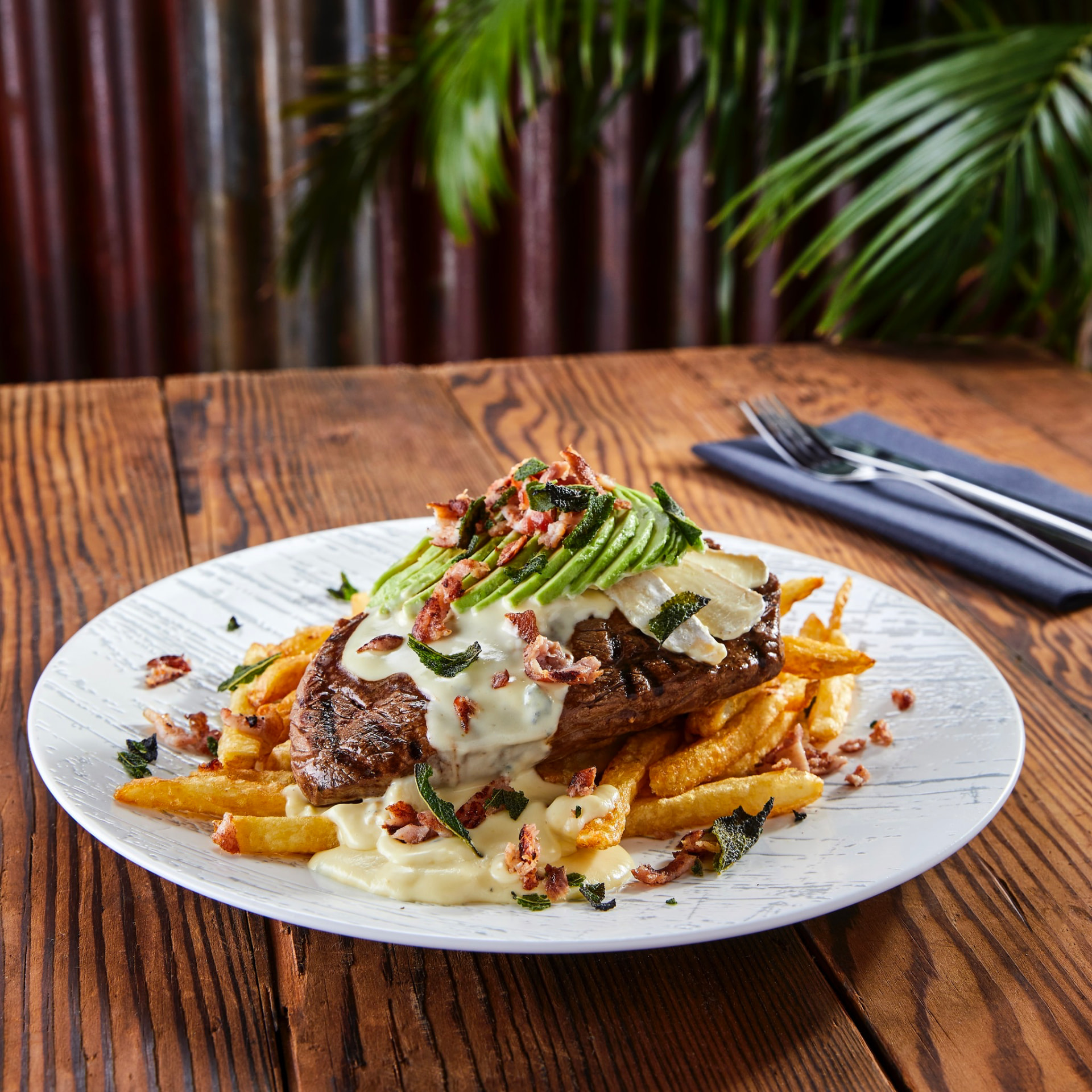 Grilled steak with avocado, bacon and fries at Jozi Gin