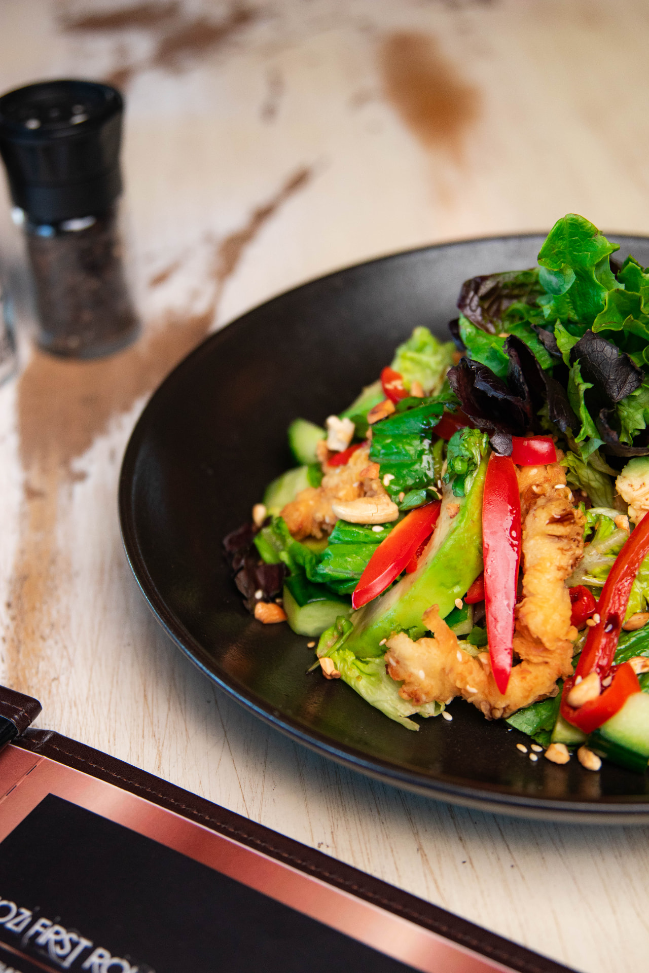 Crispy chicken salad with peppers, cucumber and cashews at Jozi Gin