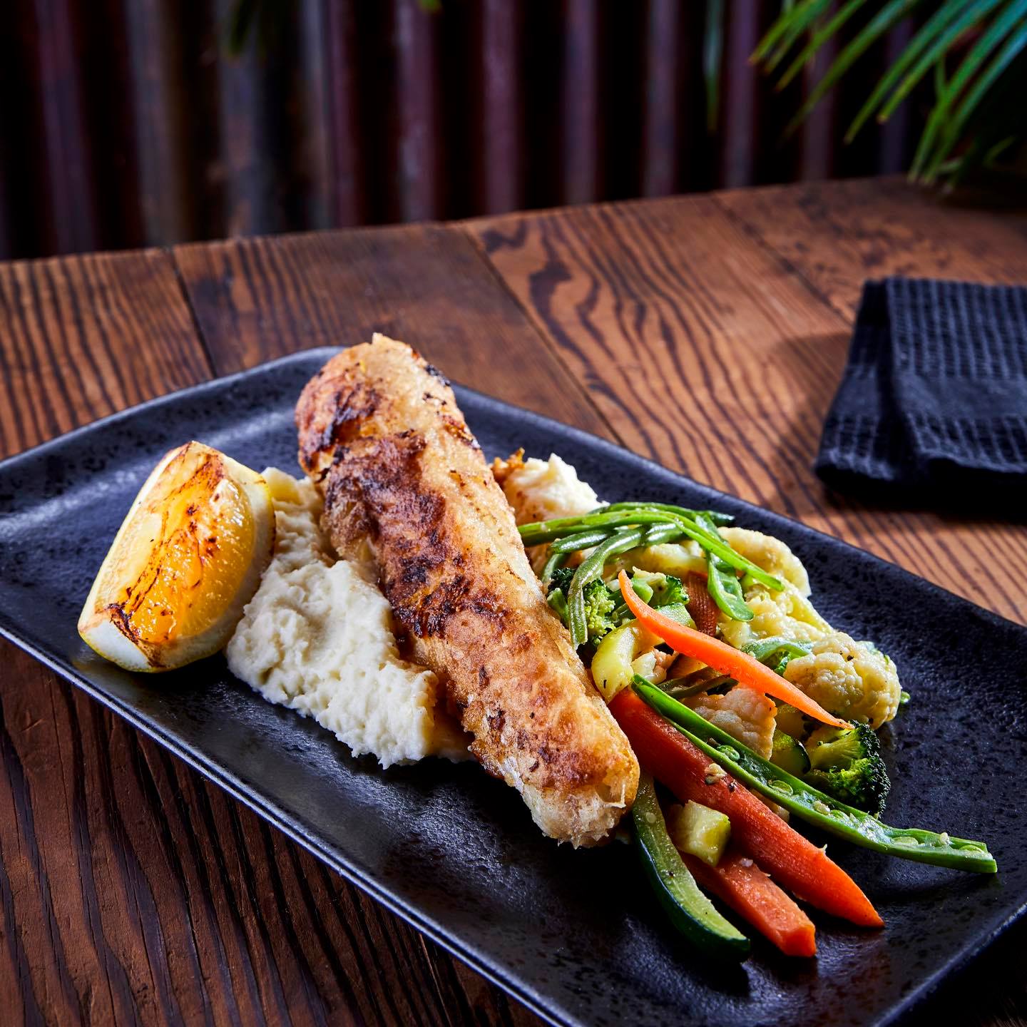 Grilled fish fillet with mash and vegetables at Jozi Gin